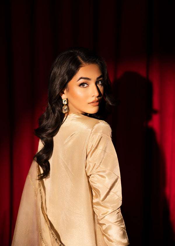 Beige raw silk outfit with emerald embroidery and zardosi detailing.