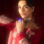 Buy Pink-Mavis raw silk kalidar dress online, featuring hand-embellished red & silver crystals, dabka work, scalloped hemline, embroidered chiffon dupatta, and tailored cigarette pants.