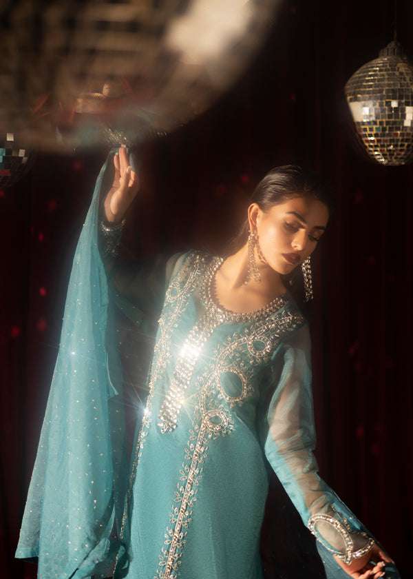 Teal organza outfit with hand-embellished Swarovski crystals, sheer organza dupatta, and raw silk pants.
