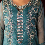 Teal organza outfit with hand-embellished Swarovski crystals, sheer organza dupatta, and raw silk pants.