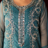 Teal organza outfit with hand-embellished Swarovski crystals, sheer organza dupatta, and raw silk pants.