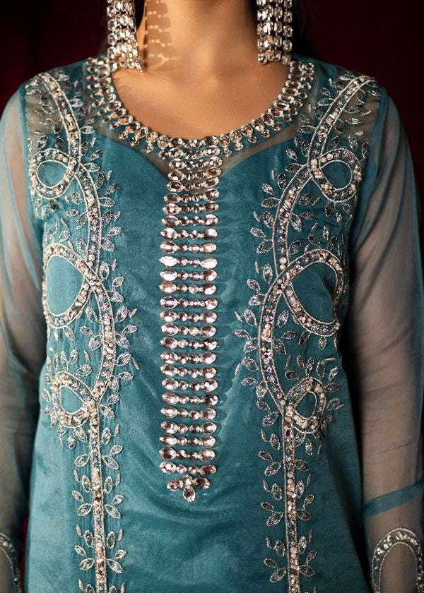 Teal organza outfit with hand-embellished Swarovski crystals, sheer organza dupatta, and raw silk pants.