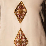 White raw silk kaftan with zardosi, sequins, and beadwork.