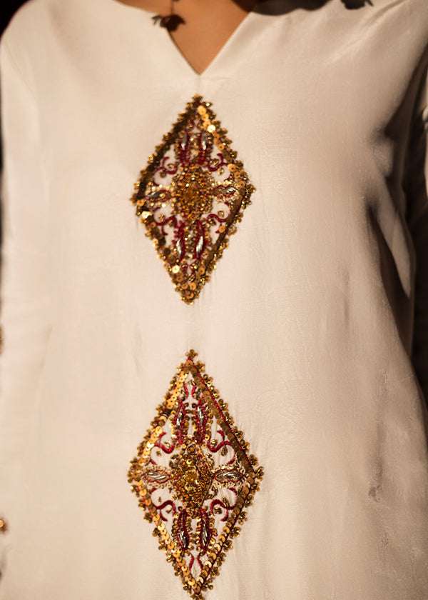 White raw silk kaftan with zardosi, sequins, and beadwork.