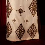 White raw silk kaftan with zardosi, sequins, and beadwork.