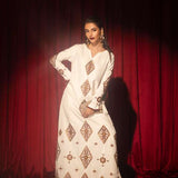 White raw silk kaftan with zardosi, sequins, and beadwork.