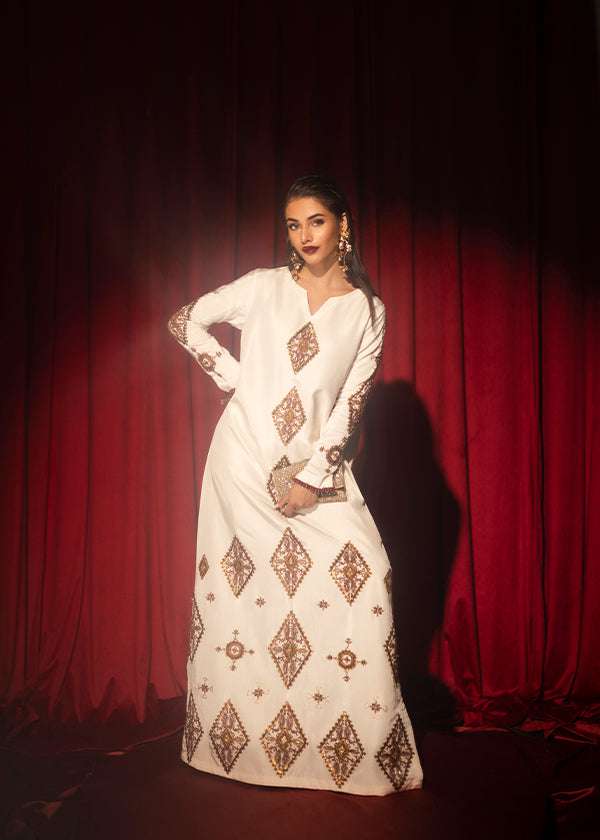 White raw silk kaftan with zardosi, sequins, and beadwork.