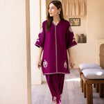 Magenta straight-cut embroidered shirt with delicate powder pink motifs, paired with a sleek skinny shalwar from COCO.