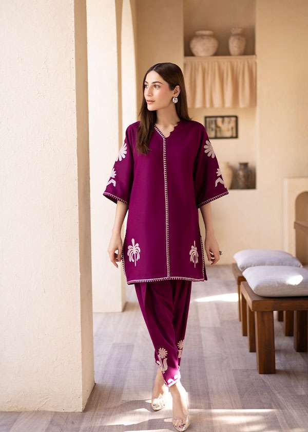 Magenta straight-cut embroidered shirt with delicate powder pink motifs, paired with a sleek skinny shalwar from COCO.