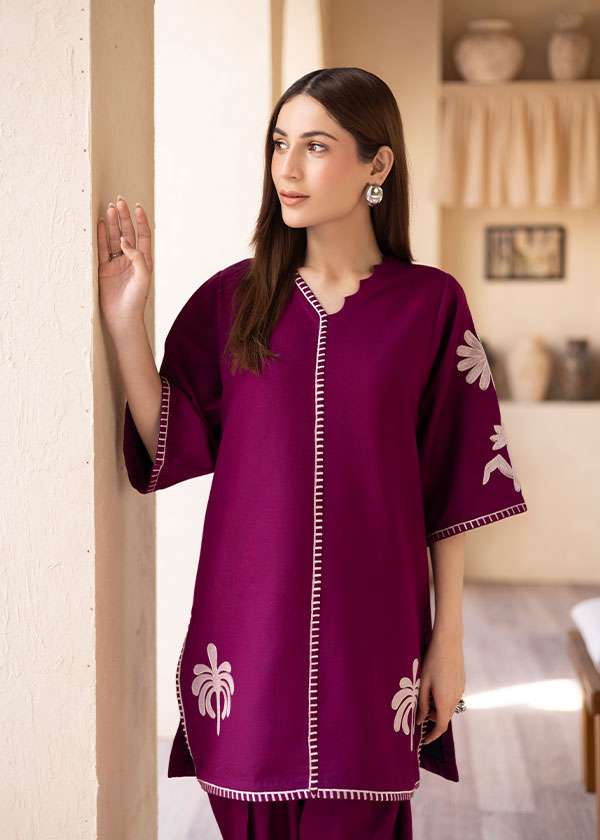 Magenta straight-cut embroidered shirt with delicate powder pink motifs, paired with a sleek skinny shalwar from COCO.