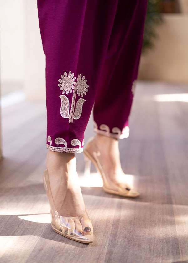 Magenta straight-cut embroidered shirt with delicate powder pink motifs, paired with a sleek skinny shalwar from COCO.