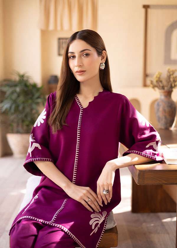 Magenta straight-cut embroidered shirt with delicate powder pink motifs, paired with a sleek skinny shalwar from COCO.