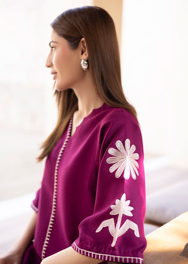 Magenta straight-cut embroidered shirt with delicate powder pink motifs, paired with a sleek skinny shalwar from COCO.