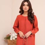 Carnelian rust raw silk suit with subtle pleats and a flowy silhouette