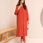 Carnelian rust raw silk suit with subtle pleats and a flowy silhouette