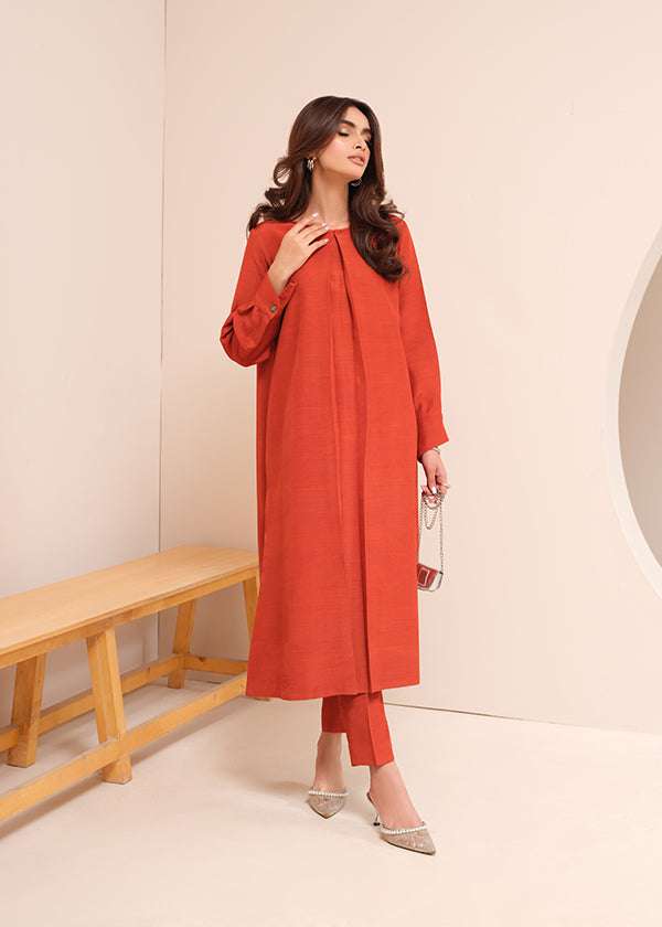 Carnelian rust raw silk suit with subtle pleats and a flowy silhouette