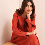 Carnelian rust raw silk suit with subtle pleats and a flowy silhouette