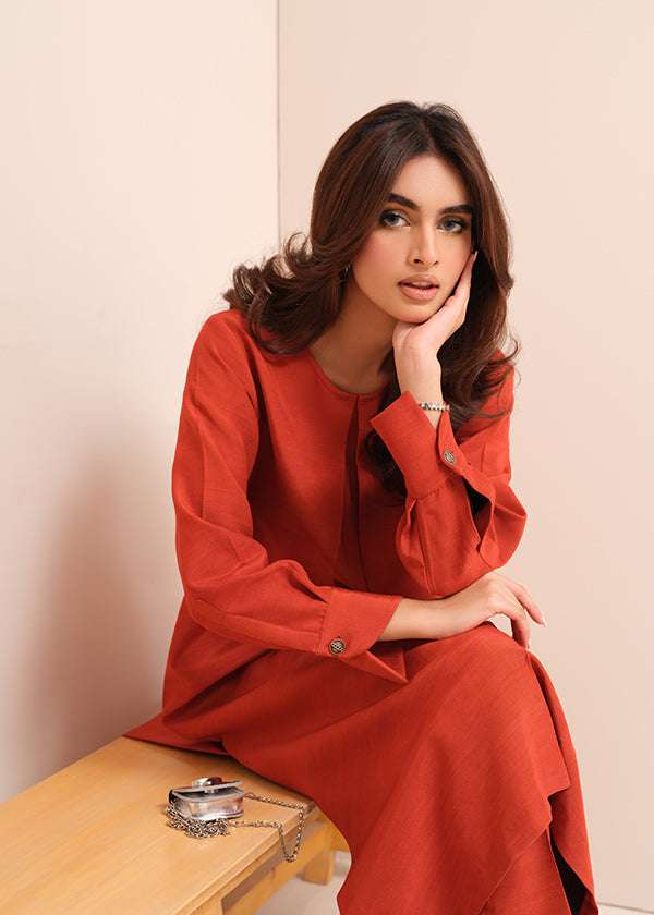 Carnelian rust raw silk suit with subtle pleats and a flowy silhouette