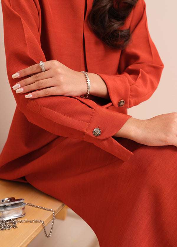 Carnelian rust raw silk suit with subtle pleats and a flowy silhouette