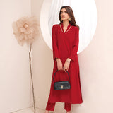 Crimson crepe suit with V-neck and minimalist stitching, exuding understated luxury.