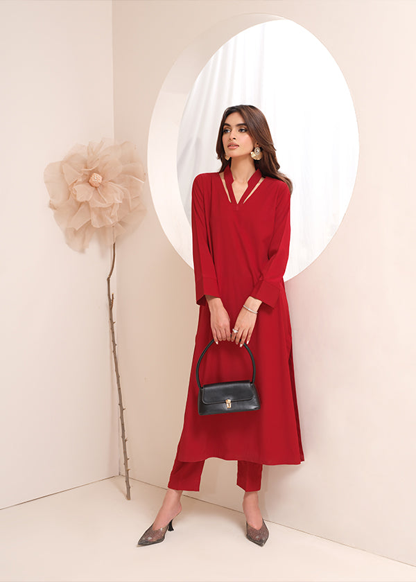Crimson crepe suit with V-neck and minimalist stitching, exuding understated luxury.