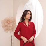 Crimson crepe suit with V-neck and minimalist stitching, exuding understated luxury.