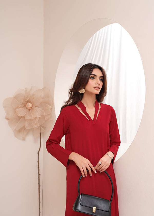 Crimson crepe suit with V-neck and minimalist stitching, exuding understated luxury.