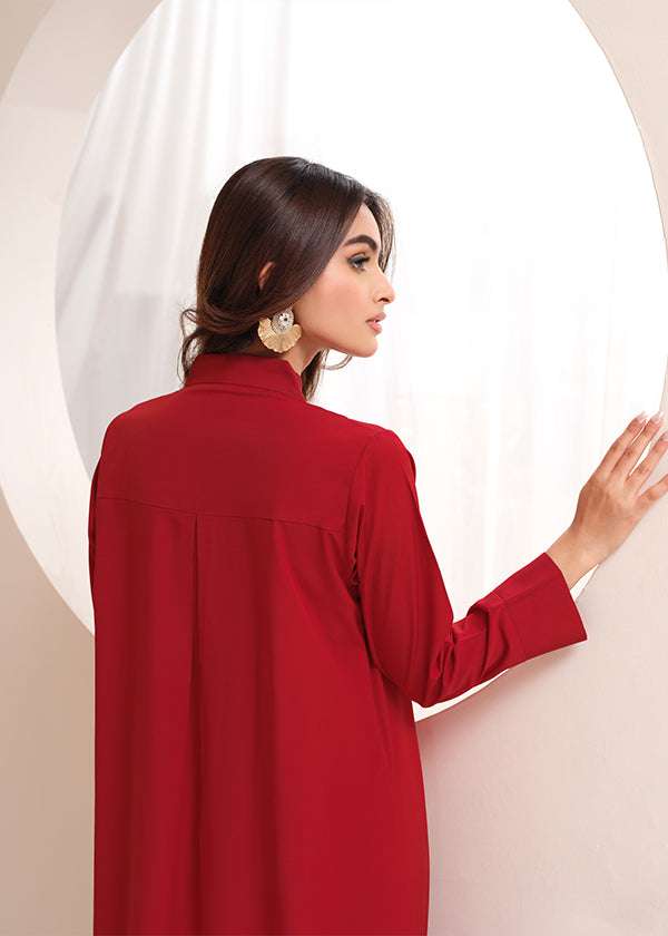 Crimson crepe suit with V-neck and minimalist stitching, exuding understated luxury.