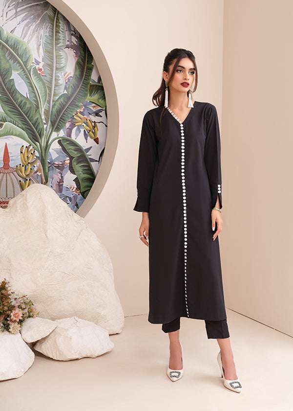 Black onyx crepe suit with white loop-button detailing and straight pants