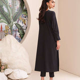 Black onyx crepe suit with white loop-button detailing and straight pants