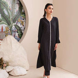 Black onyx crepe suit with white loop-button detailing and straight pants